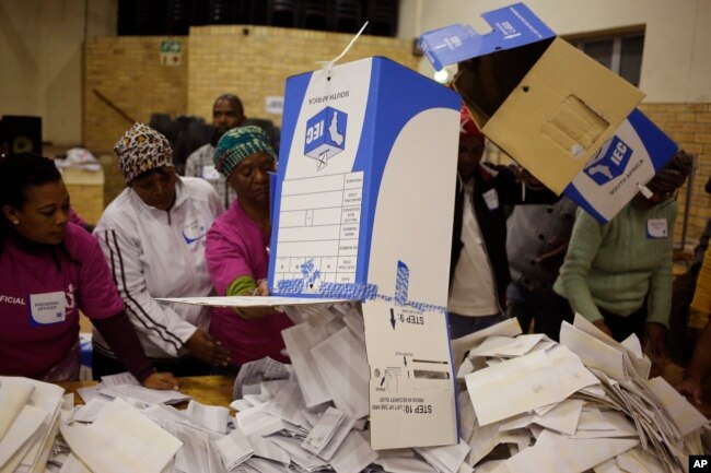 FILE - Election officials start the ballot-counting process at a polling station during municipal elections in Manenberg on the outskirts of Cape Town, South Africa, Aug. 3, 2016.