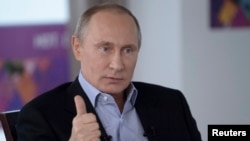 Russian President Vladimir Putin answers a journalist's question during a televised news conference in Sochi, Jan. 19, 2014. 