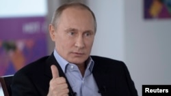 Russian President Vladimir Putin answers a journalist's question during a televised news conference in Sochi, Jan. 19, 2014.