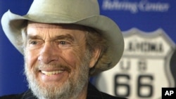 FILE - Merle Haggard smiles during a news conference at the Smithsonian's National Museum of American History in Washington, where he and his sister donated belongings taken on their family's Dust Bowl-era move to California on Route 66, May 28, 2003.