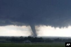 This image taken from a car window shows a tornado in Oklahoma, May 9, 2016.