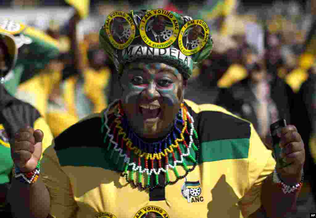 A woman sporting headgear with portraits of South African president Jacob Zuma attends a final African National Congress (ANC) election rally in Soweto, on the edge of Johannesburg.