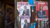 A boy enters an house with various campaign posters at the Kangemi slum in Kenya's capital Nairobi, Feb. 28, 2013. 