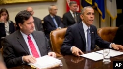 President Barack Obama, meeting with national security and public health teams about Ebola, sits beside Ebola response coordinator Ron Klain, left, at the White House, Nov. 18, 2014.