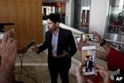 Orestes Fintiklis, manager of the Miami-based private equity fund Ithaca Capital, talks to the press in the lobby of the Trump Ocean Club International Hotel and Tower in Panama City, March 5, 2018.