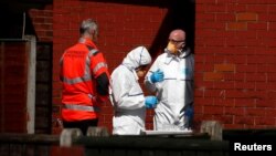 Police investigators work at residential property in south Manchester, Britain, May 23, 2017.