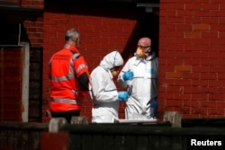 Police investigators work at residential property in south Manchester, Britain, May 23, 2017.