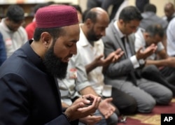 Imam Azhar Subedar, left, speaks during a special interfaith prayer service at the American Muslim Community Center in Longwood, Florida, June 13, 2016, to support the Orlando shooting victims.
