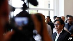 Malaysian Department of Civil Aviation, Azharuddin Abdul Rahman (R) speaks to the media after a closed door meeting with relatives of passengers on board the missing Malaysia Airlines flight MH370 at a hotel in Bangi, Malaysia, April 2, 2014.