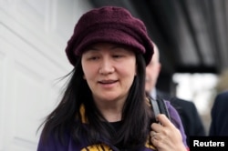 FILE - Huawei Technologies Co Chief Financial Officer Meng Wanzhou arrives back at home after her court appearance in Vancouver, British Columbia, Canada, March 6, 2019.