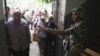 An Egyptian soldier directs a voter inside a polling station June 16, 2012 in Cairo, Egypt.