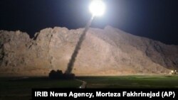 FILE - A missile is fired from city of Kermanshah, in western Iran, targeting the Islamic State group in Syria, June 19, 2017. 