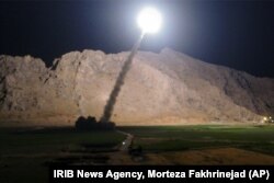 FILE - A missile is fired from city of Kermanshah, in western Iran, targeting the Islamic State group in Syria, June 19, 2017.