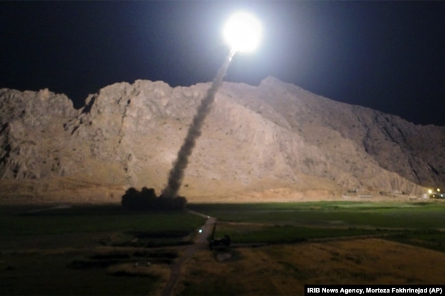 FILE - A missile is fired from city of Kermanshah, in western Iran, targeting the Islamic State group in Syria, June 19, 2017.