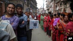 Nepalese stand in line to vote at a polling station in Bhaktapur, Nepal, May 14, 2017. Nepalese lined up to vote Sunday for representatives in municipality and village council positions held in the Himalayan nation for the first time in two decades.