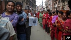 Nepalese stand in line to vote at a polling station in Bhaktapur, Nepal, May 14, 2017. Nepalese lined up to vote Sunday for representatives in municipality and village council positions held in the Himalayan nation for the first time in two decades.