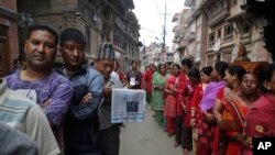 FILE - Nepalese stand in line to vote at a polling station in Bhaktapur, Nepal, May 14, 2017. Nepalese lined up to vote for representatives in municipality and village council positions held in the Himalayan nation for the first time in two decades.