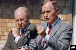 FILE - Then-Defense Secretary Dick Cheney and then-President George H.W. Bush, pictured in 1990.