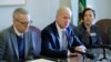 State Rep. Paul Harris R-Vancouver, center, talks to reporters, Feb. 8, 2019, following a public hearing at the Capitol in Olympia, Wash., on a bill that would remove parents' ability to to opt school-age children out of the combined measles, mumps and rubella vaccine. 