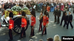 FILE - Guardsmen escort the coffin of Diana, Princess of Wales draped in the Royal Standard, as the cortege passes through crowds gathered along Whitehall. Walking behind them are the Duke of Edinburgh, Prince William, the Earl of Spencer, Prince Harry and Princ