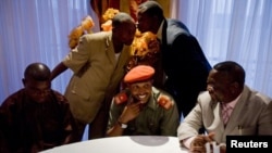 In this Jan. 16, 2009 file photo, Bosco Ntaganda, seated center, holds a press conference with Congo Interior Minister Celestine Mboyo (R), in Goma, Congo.