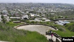 FILE - People visit a viewing platform at the Naryn-Kala fortress in the Caspian Sea coastal city of Derbent, in Dagestan, Russia, May 15, 2010. A gunman opened fire on a group of tourists visiting the site on the evening of Dec. 29, 2015.