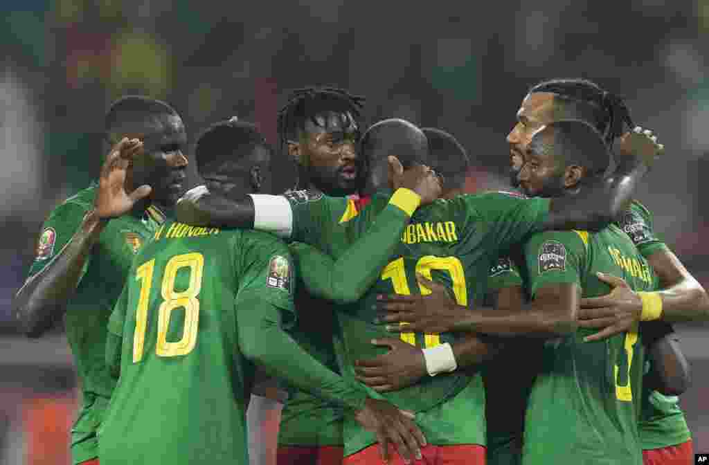 Cameroon&#39;s Karl Toko-Ekambi, center, celebrates with teammates after scoring his side&#39;s first goal against Comoros.