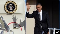 President Barack Obama waves as he arrives at Miami International Airport, Nov. 8, 2013, in Florida. 