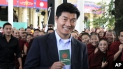 Lobsang Sengey, shows his green book as he arrives to cast his vote in Dharmsala, India (File Photo - March 20, 2011)