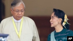 Htin Kyaw, left, newly elected president of Myanmar, walks with National League for Democracy leader Aung San Suu Kyi at Myanmar's parliament in Naypyitaw, Myanmar, Tuesday, March 15, 2016.
