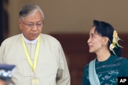 Htin Kyaw, left, newly elected president of Myanmar, walks with National League for Democracy leader Aung San Suu Kyi at Myanmar's parliament in Naypyitaw, Myanmar, Tuesday, March 15, 2016.