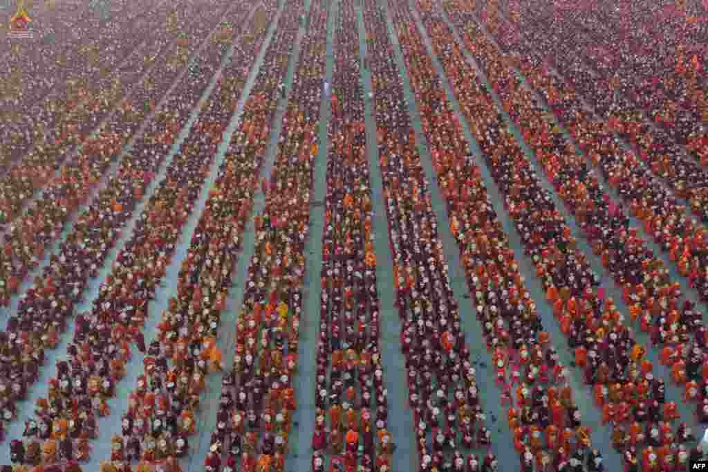 A handout photo released by Dhammakaya Fondation shows monks lining up for alms during the alms-giving ceremony to 30,000 monks organized by the regional government of Mandalay affiliated with Dhammakaya Foundation at Chanmyatha Airport in Mandalay, Myanmar.