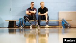 Britain's Prince Harry sits with an athlete at the Toronto Pan Am Sports Centre ahead of the Invictus Games in Toronto, Sept. 22, 2017. 