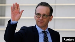 FILE - German Foreign Minister Heiko Maas waves upon his arrival to meet with Palestinian President Mahmoud Abbas meets in Ramallah, in the occupied West Bank, March 26, 2018. 