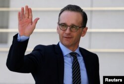 FILE - German Foreign Minister Heiko Maas waves upon his arrival to meet with Palestinian President Mahmoud Abbas meets in Ramallah, in the occupied West Bank, March 26, 2018.