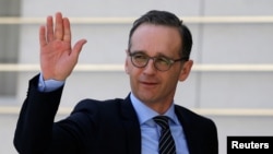 FILE - German Foreign Minister Heiko Maas waves upon his arrival to meet with Palestinian President Mahmoud Abbas meets in Ramallah, in the occupied West Bank, March 26, 2018. 