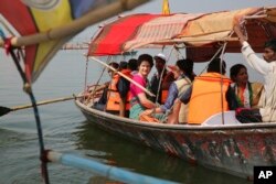 Congress party General Secretary and eastern Uttar Pradesh state in-charge Priyanka Gandhi Vadra, center, takes a boat ride to the Sangam, the confluence of sacred rivers the Yamuna, the Ganges and the mythical Saraswati, in Prayagraj, India, March 18, 2019.
