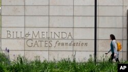 FILE - A person walks by the headquarters of the Bill and Melinda Gates Foundation in Seattle, Washington, April 27, 2018. 