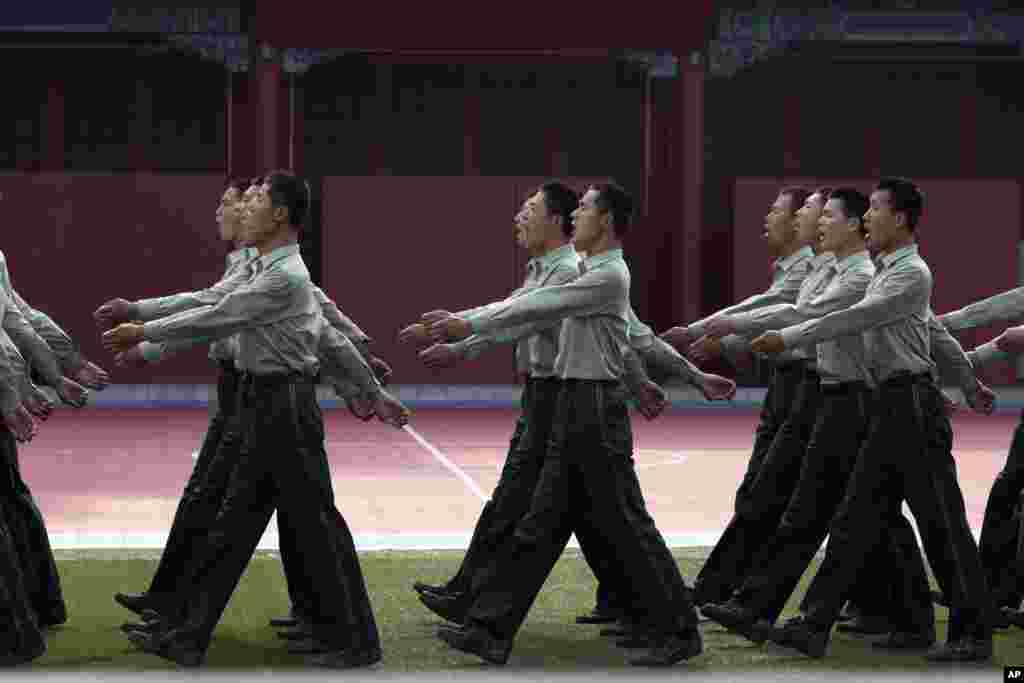 Chinese paramilitary policemen chant slogans as they march at a barrack near Tiananmen Gate in Beijing, June 4, 2014.