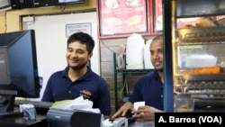 Employees look after customers at Aladdin Sweets & Cafe in Banglatown, Hamtramck, Michigan.