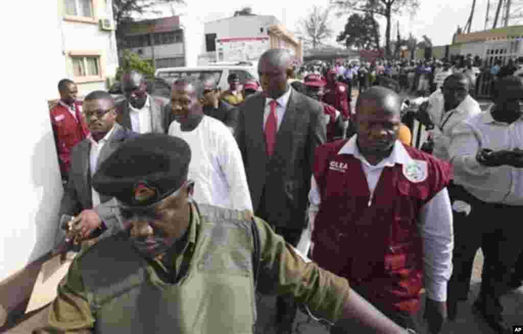 Nigerian comedian Baba Suwe, whose real name is Babatunde Omidina, center, arrive for court hearing at a Federal High Court in Lagos, Nigeria, Tuesday, Nov. 1, 2011. The court on Friday ordered authorities to free the popular actor who has been held for m