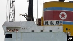 North Korean sailors stand on the deck of the North Korean-flagged cargo ship Chong Chon Gang in Sherman Bay near Colon City, Panama, February 12, 2014. 
