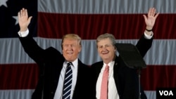 U.S. President-elect Donald Trump waves with John Kennedy, who won the race Saturday for a seat in the U.S. Senate from Louisiana, during a "Thank You USA" tour rally in Baton Rouge, Louisiana, Dec. 9, 2016.