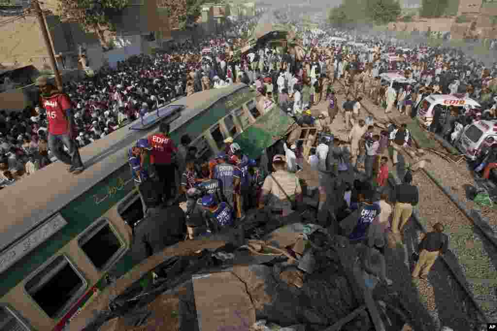 People look for victims in the wreckage of the trains in Karachi, Pakistan. Officials said a train crash has killed dozens of people in the southern port city.&nbsp;