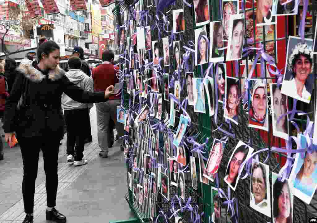 A woman looks at a photo exhibition of murdered women staged as a protest in Ankara, Turkey, ahead of International Women's Day on Sunday.