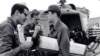 In this undated photo taken some time in the early to mid 1960s, from L to R, reporters David Halberstam (New York Times), Malcolm Brown (Associated Press) and Neil Sheehan (UPI) chat beside a helicopter in Vietnam.