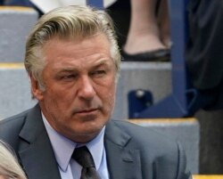 FILE - Alec Baldwin watches the men's singles final of the U.S. Open tennis championships, Sept. 12, 2021, in New York.