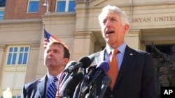 FILE - Virginia Attorney General Mark Herring, right, accompanied by Virginia Solicitor General Stuart Raphael, speaks outside the federal courthouse in Alexandria, Va., Friday, Feb. 10, 2017, following a hearing on President Donald Trump's travel ban.