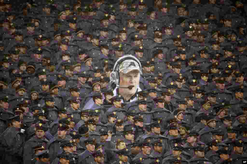 Army cadets hold a large photo of Army head coach Rich Ellerson during an NCAA college football game against Navy in Philadelphia, Pennsylvaina, Dec. 14, 2013. Navy won 34-7. 