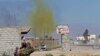 FILE - A chlorine-tinged cloud of smoke rises into the air from an Islamic State bomb that was detonated by Iraqi army and Shi'ite fighters in the town of al-Alam in Salahuddin province, Iraq, March 10, 2015.